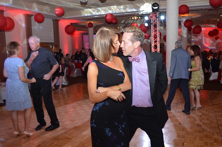 Co-Chairwoman Penny Hill dances with James Helmich.