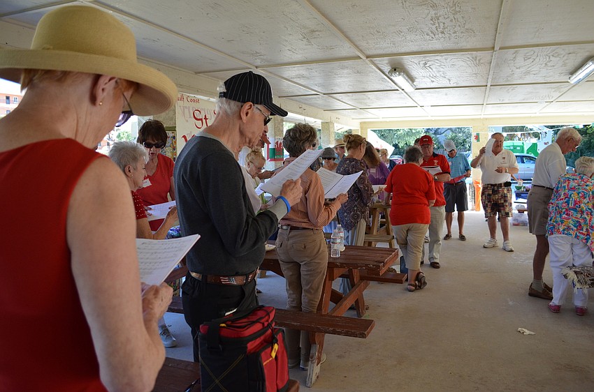 Members and guest stand to sing 
