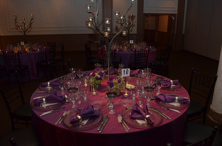 The table settings at Michael’s On East welcome guests with an elegant purple and silver theme.