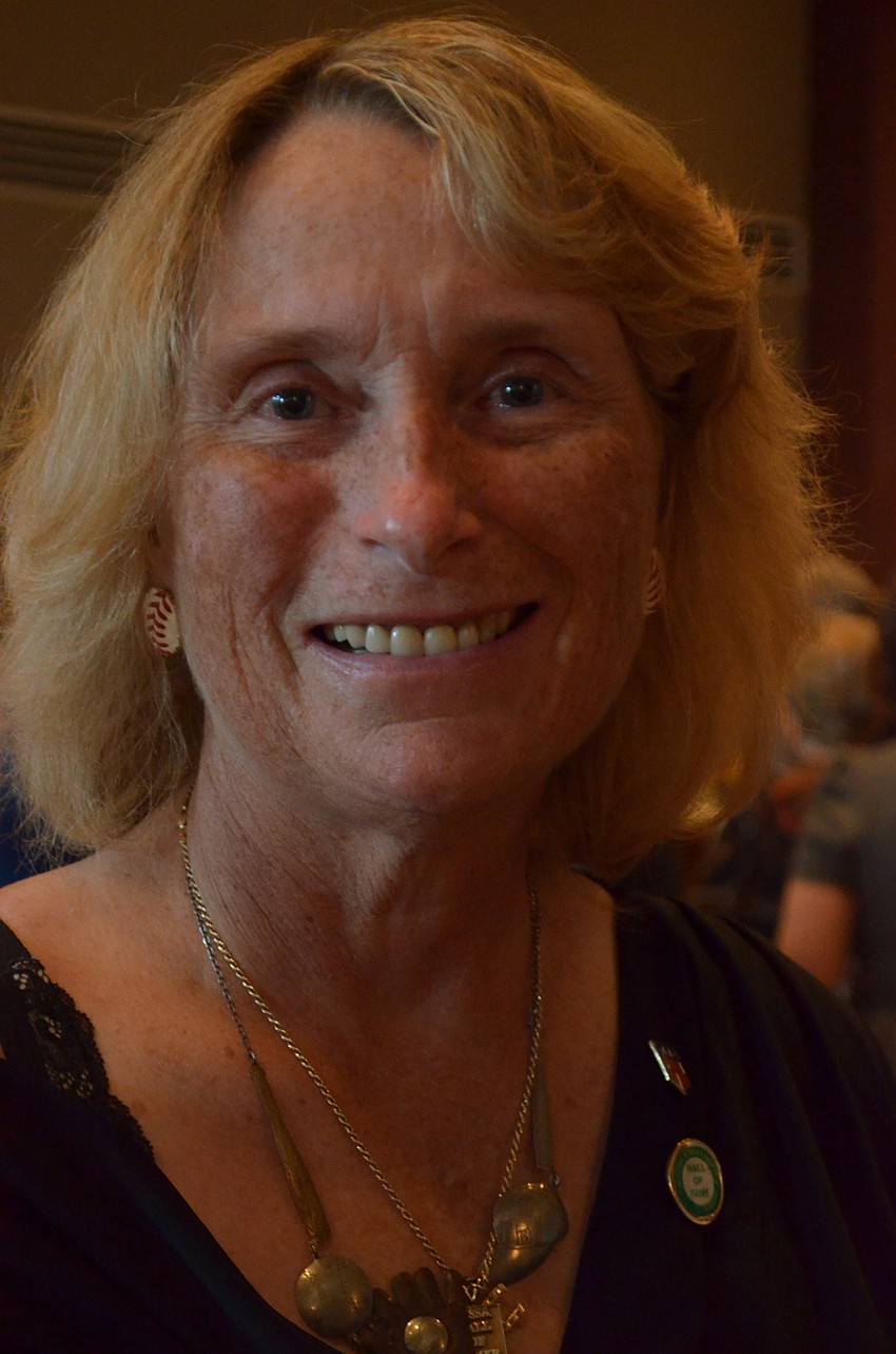 Carol Sheldon shows off her baseball earrings and accessories.