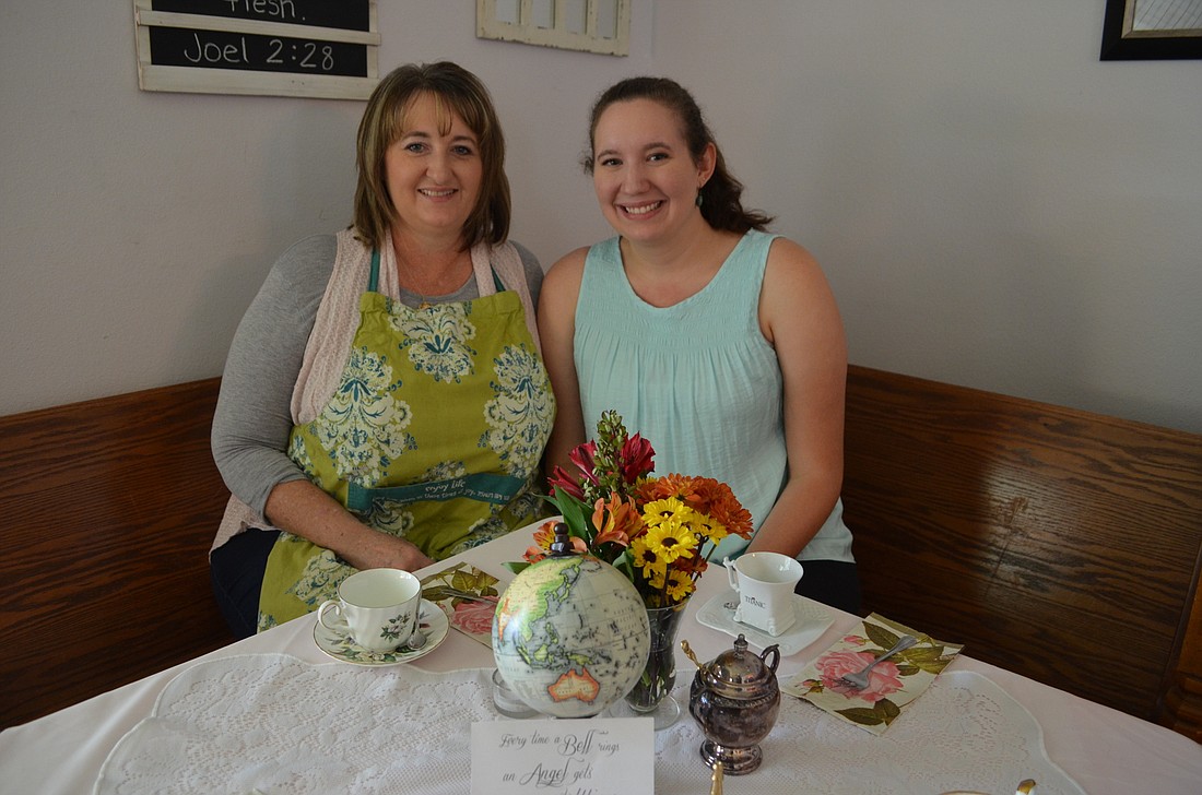 Mother and daughter Cynthia Schrock and Ashley host guests in their home tea parlor to benefit mission trips.
