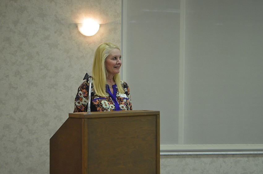 Club president Susan Phillips welcomes the members back.