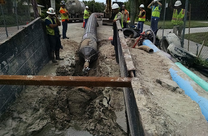 Crews work to pull piping as part of the Lift Station 87 project. The construction has been a round-the-clock effort â€” a necessary evil to complete the work, officials said.