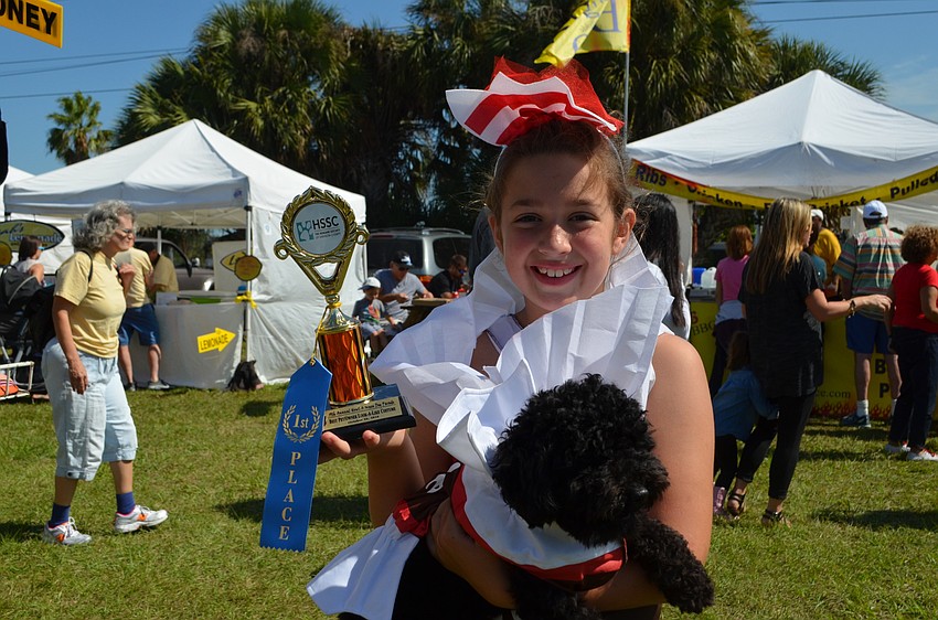 Grace Morgan and her 1-year-old pup Pepper won the category of pet/owner look-a-like dressed as tootsie rolls.