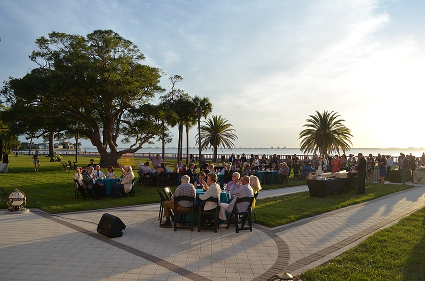 Guests enjoy a catered meal on the beautiful lawn of the College Hall, AKA New College mansion.