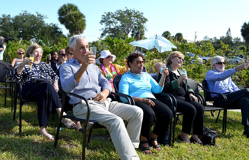 Attendees toast to the project.
