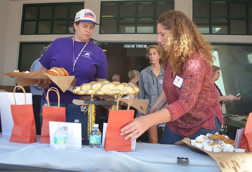Amy Meese and Sheri Weiss organize the entries on the table before tasting began.