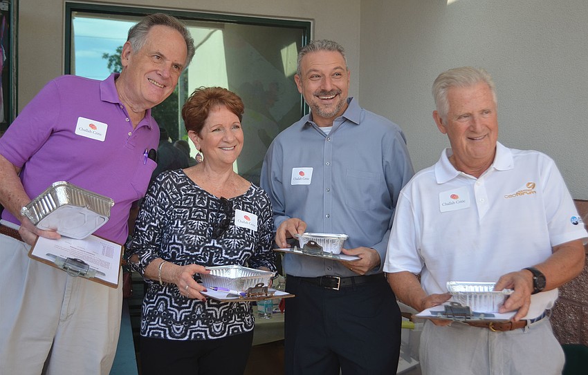 Richard Hershorn, Patti Wertheimer, Rabbi Michael Shefrin and Ian Black pose for a photo before selecting their samples.