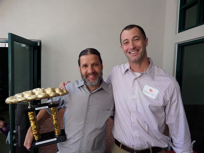Head of School Dan Ceaser poses with first-place-winner Rabbi Michael Werbow.