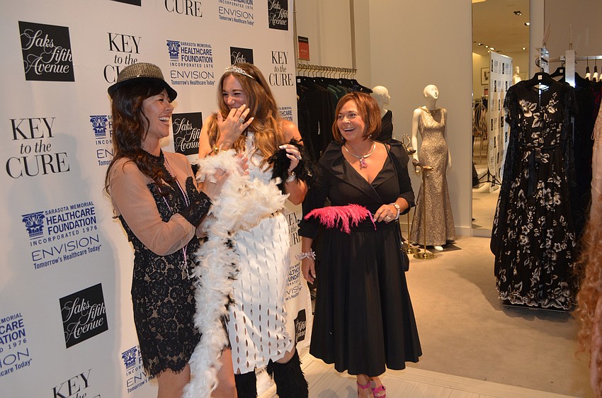 Rosemary Angeleri, Lathrop Ford and Sandy Cohen laugh after getting their photos taken at the photobooth.