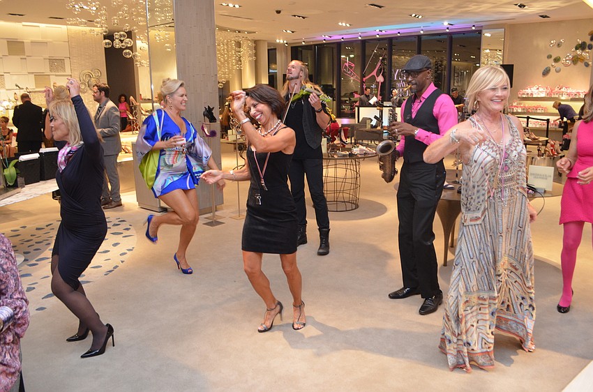 Attendees dance with musicians towards the end of the night.