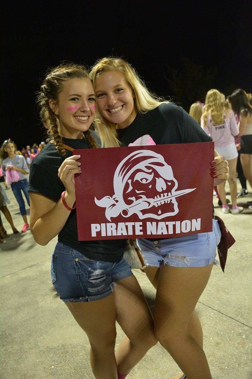 Danielle Thimons and Sydni Polinski, both seniors, show off their school pride.