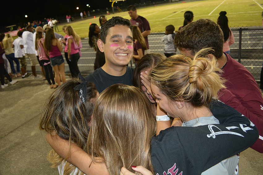 Freshman Sebastian Colosia gets a group hug.