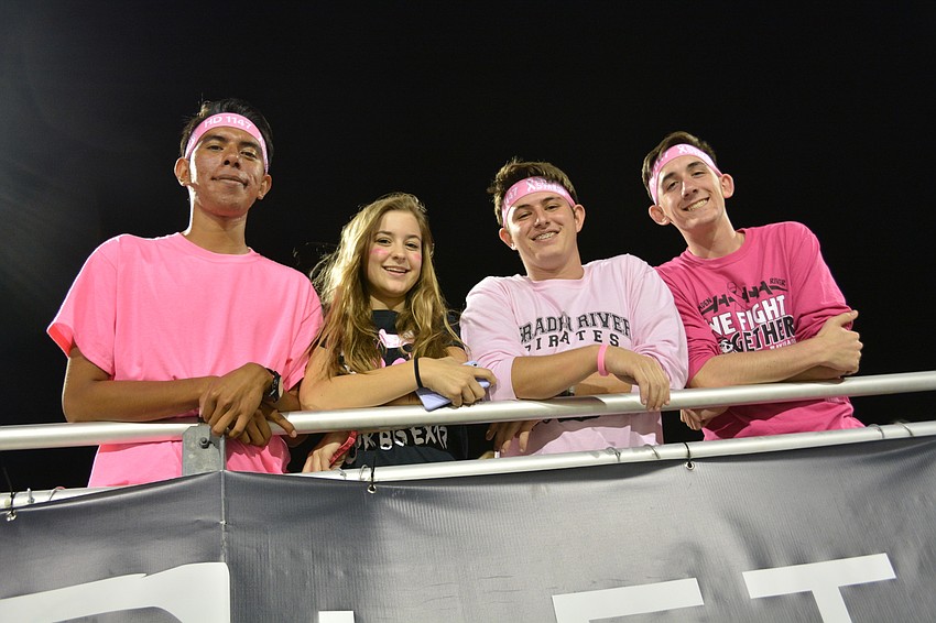 Adrian Aguayo, Lily Slotabec, Chandler Shepard and Max Grim, all seniors, sport pink during the game to raise awareness for breast cancer.