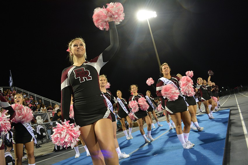 Varsity cheerleader Kirsten Oteri, a freshman, shouts in support of the football team.