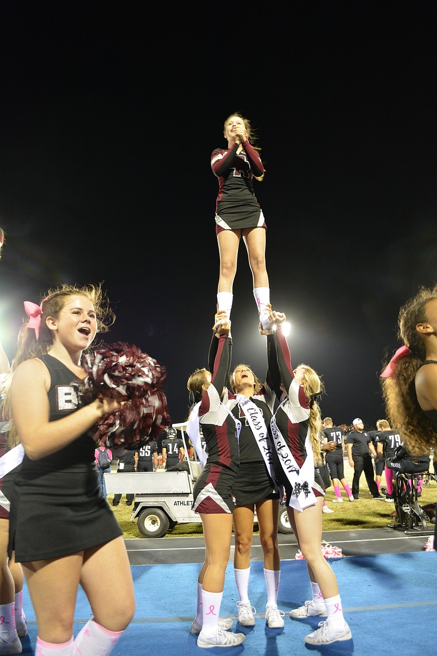 Braden River High's junior and varsity cheerleading squads work together for a stunt for the crowd.