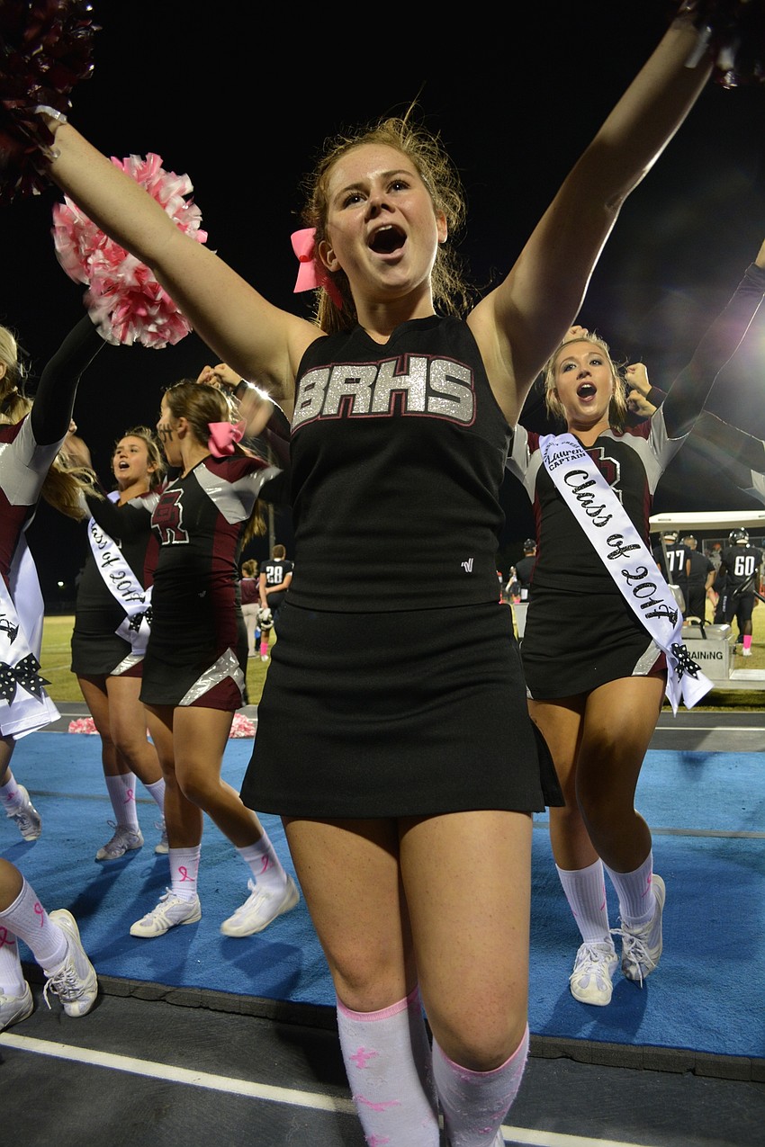Junior varsity cheerleader Rylee Willard, a freshman, shouts in support of the football team.