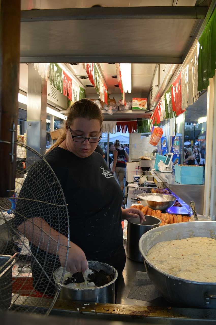 Vendor Ashley Guagenci prepares fried Oreos for the crowd.