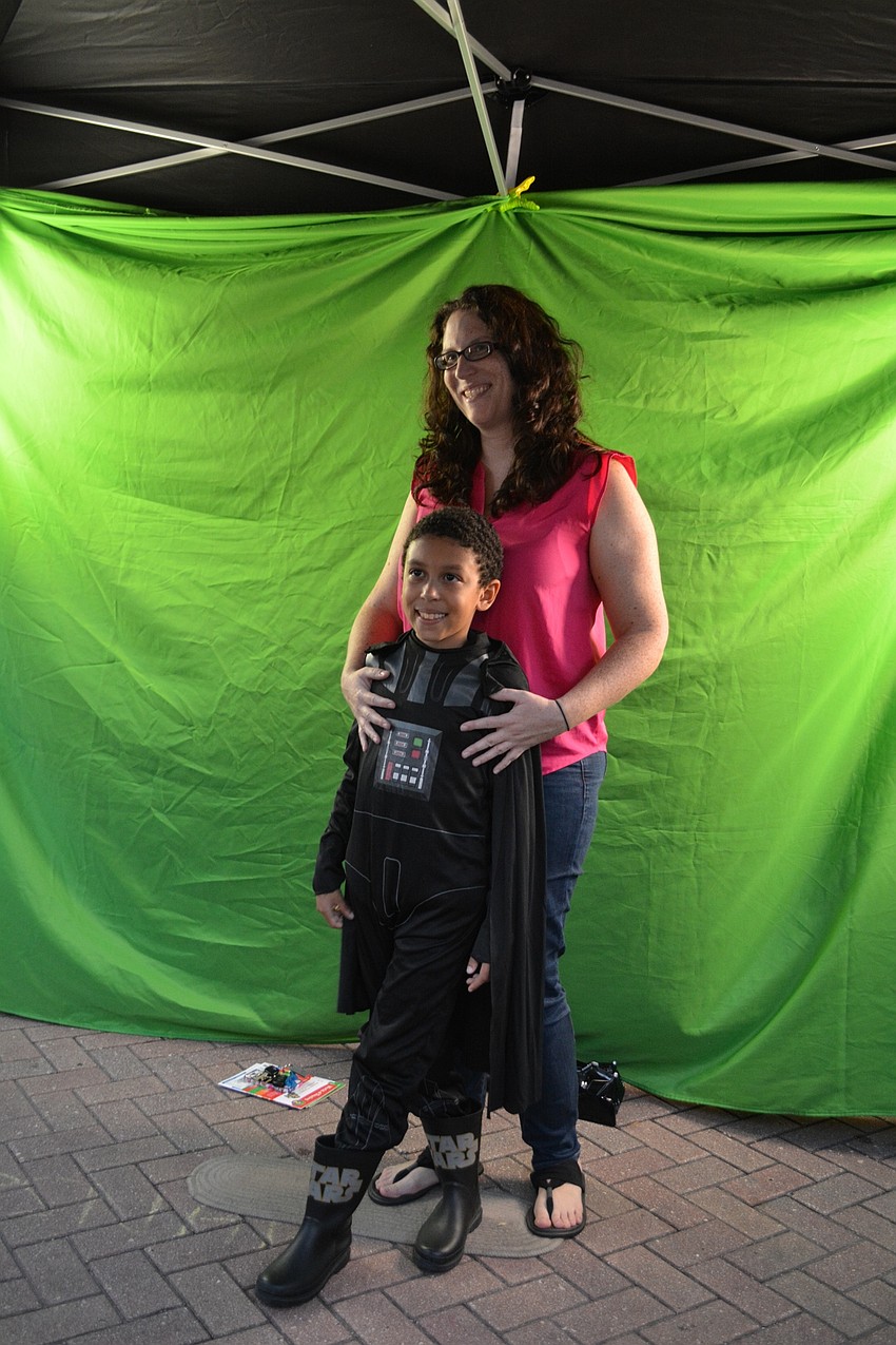 Diane and Andres Carabali, of Lakewood Ranch, pose for a picture at TapSnap Phototainment, which placed a Halloween-themed background into the picture.