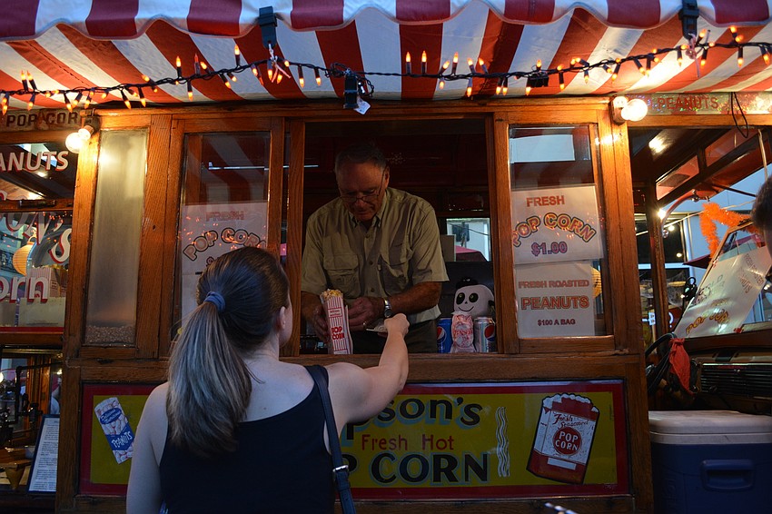 Ted Kreger passes Lakewood Ranch resident Melissa Broderick a box of popcorn.