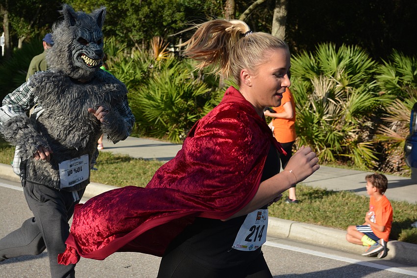 Brittany Parker had an advantage during the Boo Run because she was being chased by a wolf, Ryan Hoppe. The Lakewood Ranch residents were hoping to win the costume contest.