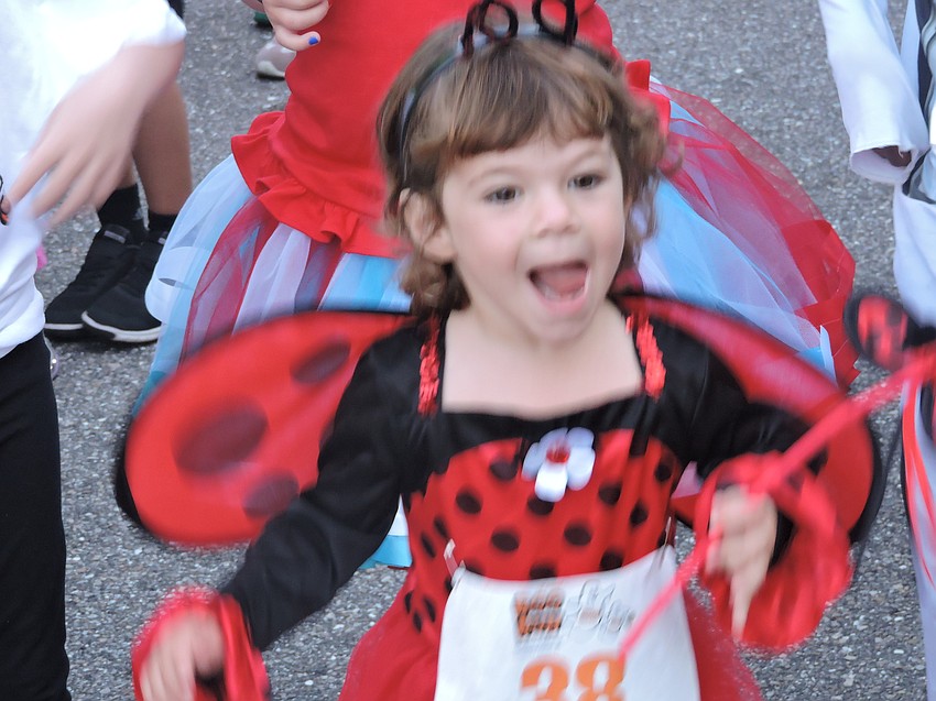 Sarasota's Findley Frost, 2, enjoys a magical effort during the Boo Run.