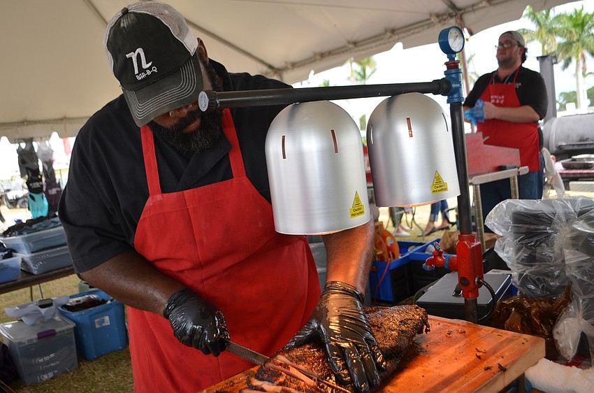 Gordon Gregory of Nancy’s Bar-B-Q cuts Texas-style beef brisket.