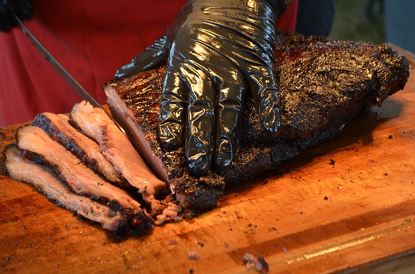 Gordon Gregory of Nancy’s Bar-B-Q cuts Texas-style beef brisket.