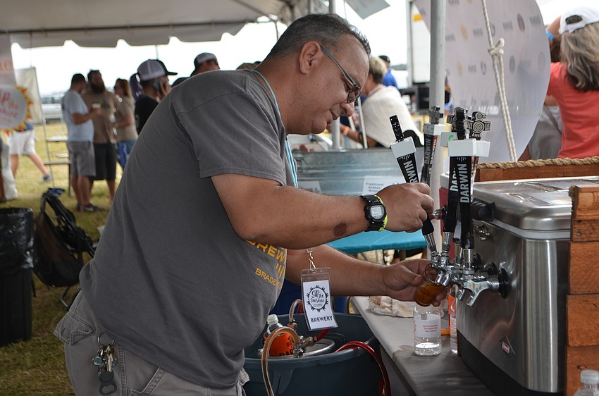 Jorge Rosabal, owner of Darwin Brewing Company, pours samples during Sip the Sunshine.