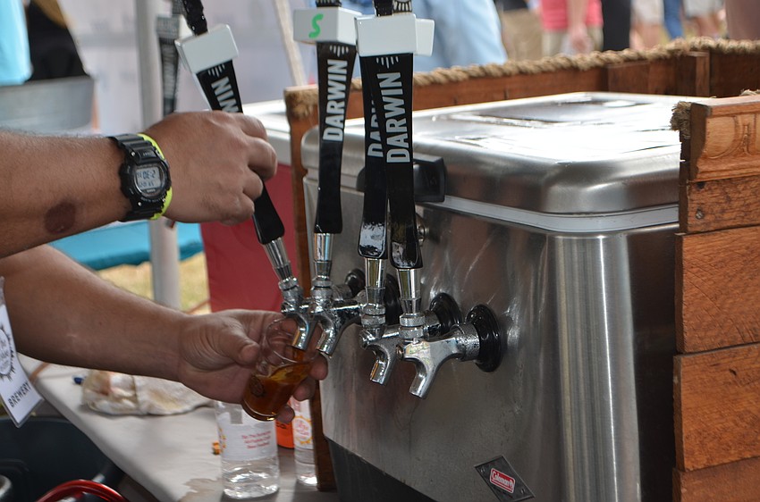 Jorge Rosabal, owner of Darwin Brewing Company, pours samples during Sip the Sunshine.