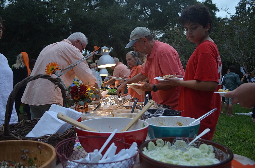 Neighbors enjoyed food, drinks and live music at the Laurel Park Neighborhood Association's Tunes in the Park potluck.