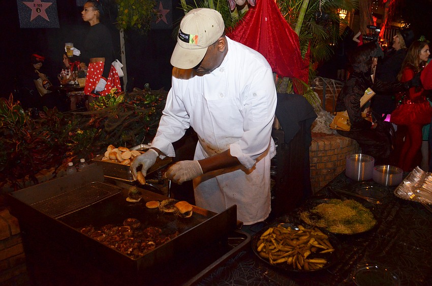 Juan Sogo of Michael’s On East grills cheeseburger sliders for guests in the atrium.