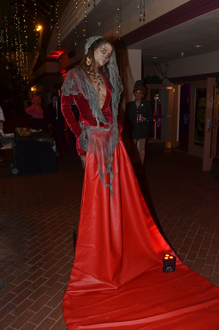 A model welcomes guests at the end of the “Haunted Hollywood” runway.