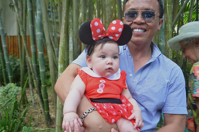 Veth Senenoi holds Ragan Reilly, who dressed up like Mini Mouse.