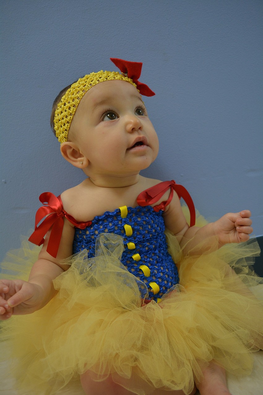 Aliya Lugo, 9 months, sports a Snow White costume her mother Amanda Hilton, a teacher at Kiddie Academy, had made for her.