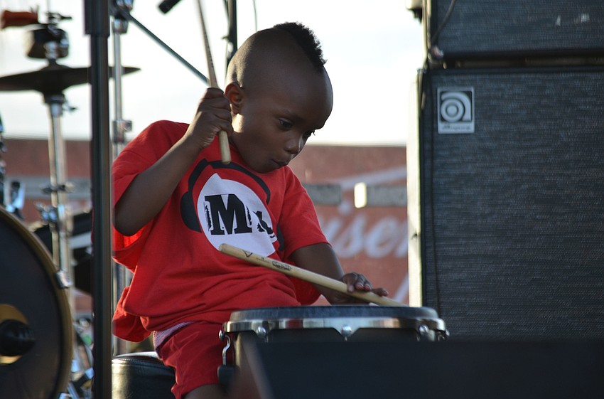 Ky-mani Caies helps joined his parents, Damie Caies and Shantel Norman of Jah Movement, on stage.