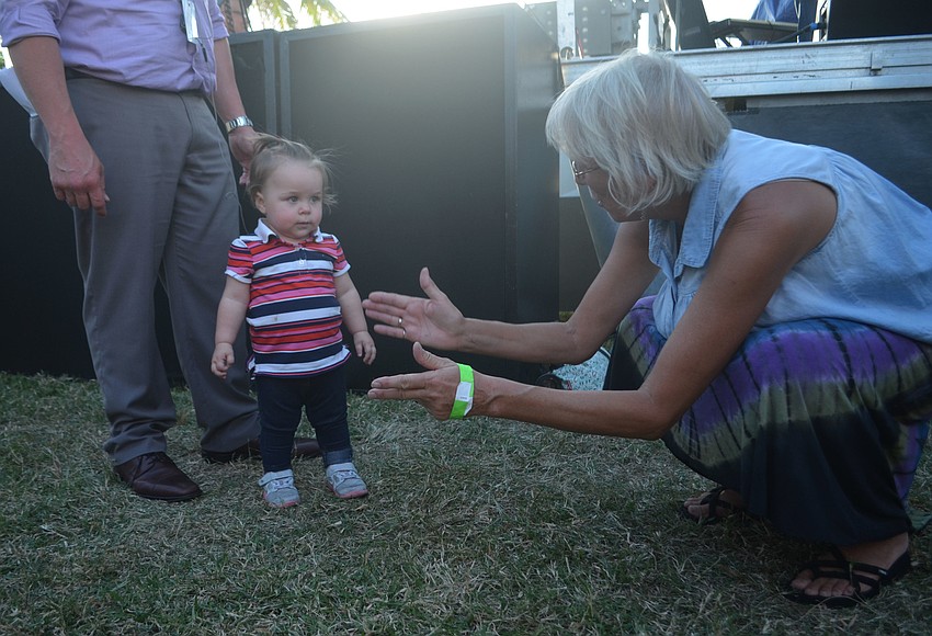 Kathy Averitt encourages one-year-old Liliana Hanoch during Jah Movement's concert at Giving Hunger the Blues.