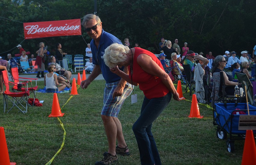 Joan Russel and HJ Sauer dance to the electric slide.