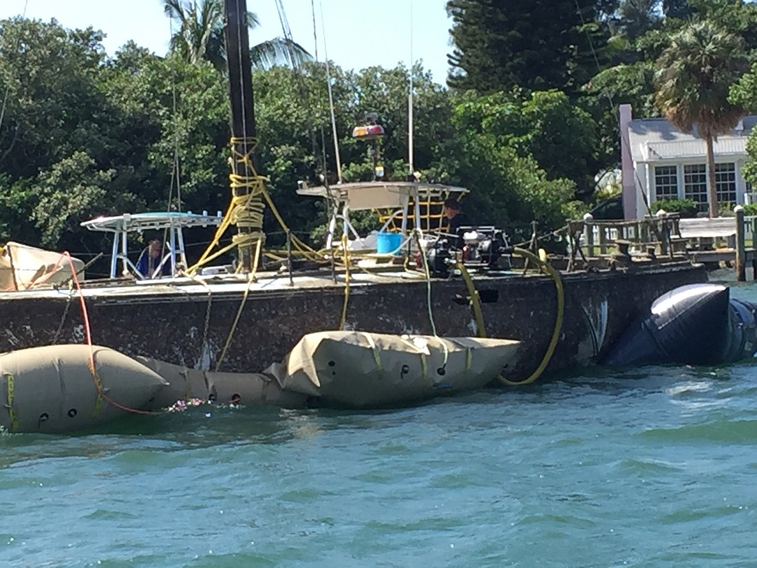 Blenker Boatworks and Marina of Bradenton worked  two days to raise the sunken sailboat. Note the inflated baldders that float the wreck. Courtesy photo