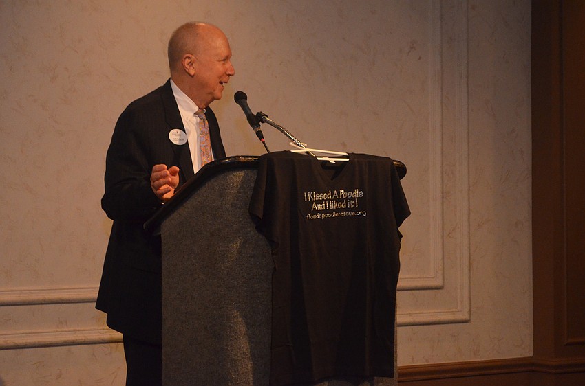 Scott Anderson, emcee, welcomes guests and encourages them to buy bedazzled “I Kissed a Poodle and I Liked It!” shirts.
