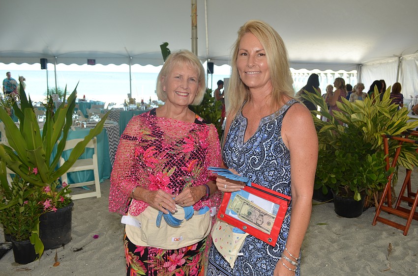 Pat Williams and Lisa Jackson sell raffle tickets to raise money for Children First.