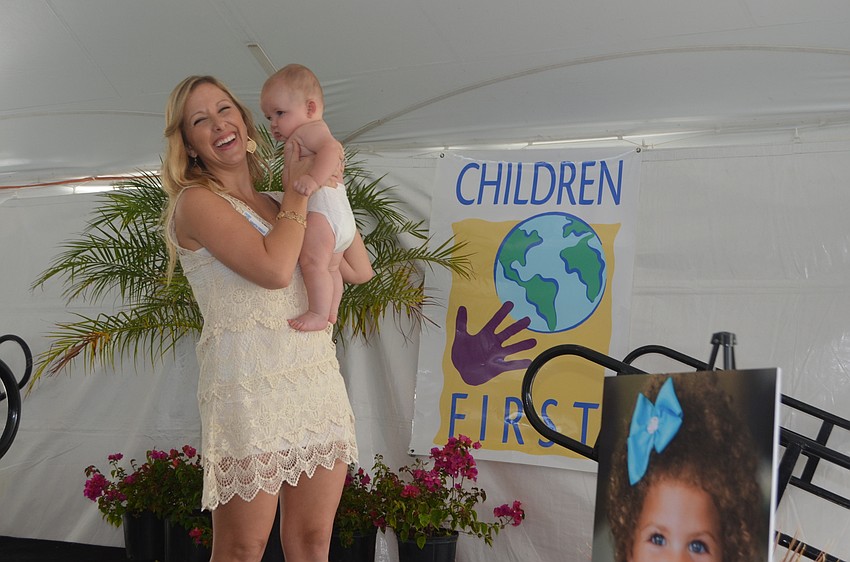 Development Manager Samantha Kingsley hits the stage with son Cooper, the first model of the show.