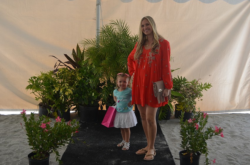 Melissa Hembree strikes a pose on the runway with daughter Annabelle, both in outfits from Malibu Fox.