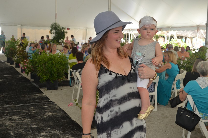 Jennifer Kelly walks the runway with her daughter Ava, both in outfits from Malibu Fox.