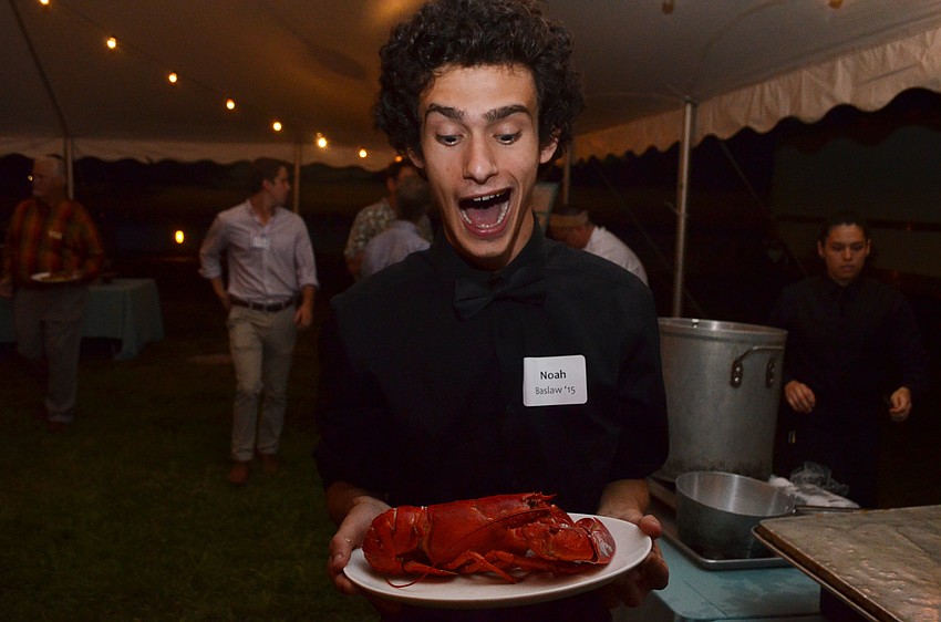 Noah Baslaw gets excited to eat his lobster, provided by Michael’s On East.