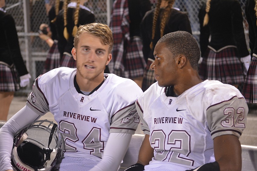 Riverview senior teammates Nathan Suplee, a wideout, and Vince Sellers, a running back, chat on the bench late in the Rams' 42-24 win over Sarasota on Nov. 4.