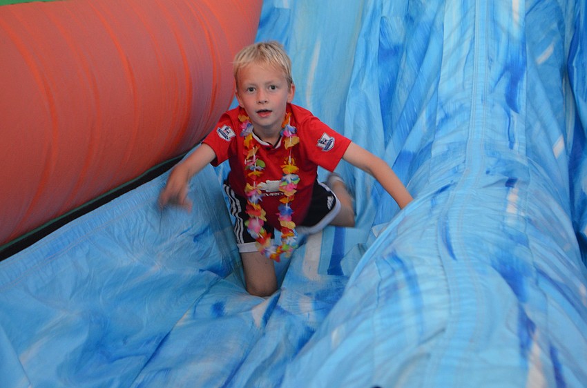 Country Club East 8-year-old Ryan Catlett gets a thrill out of an inflatable slide.