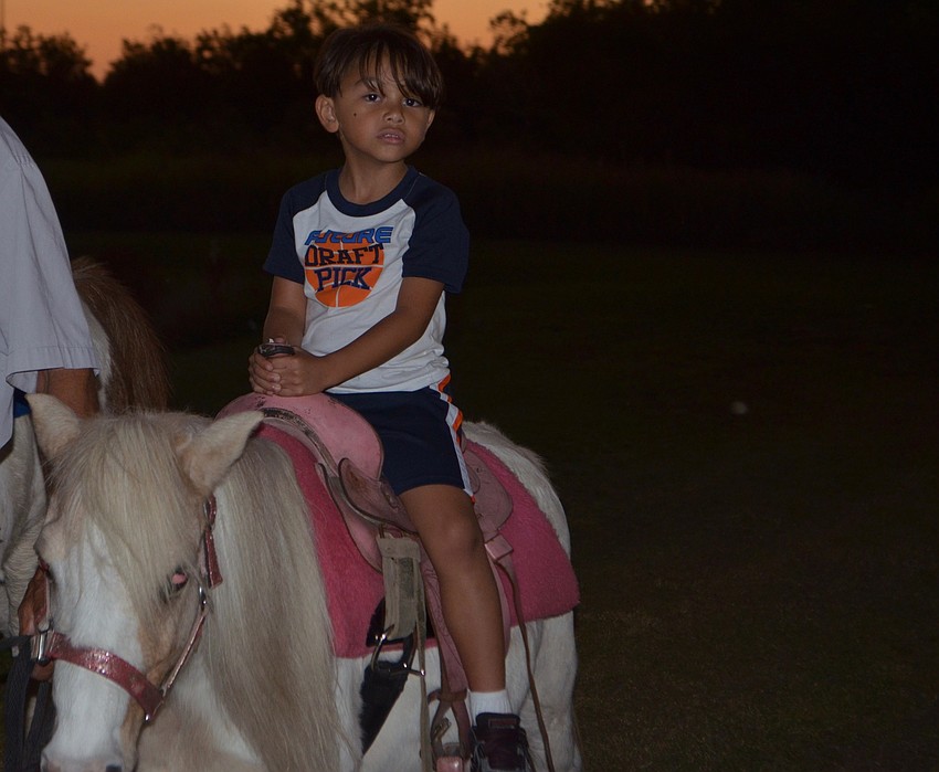 Heritage Harbor's Zenmar Cardenio-Santiago, 5, finishes his pony ride.