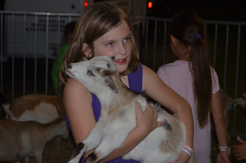 Lakewood Ranch's Allison Rothaar, 6, snuggles with a small goat.