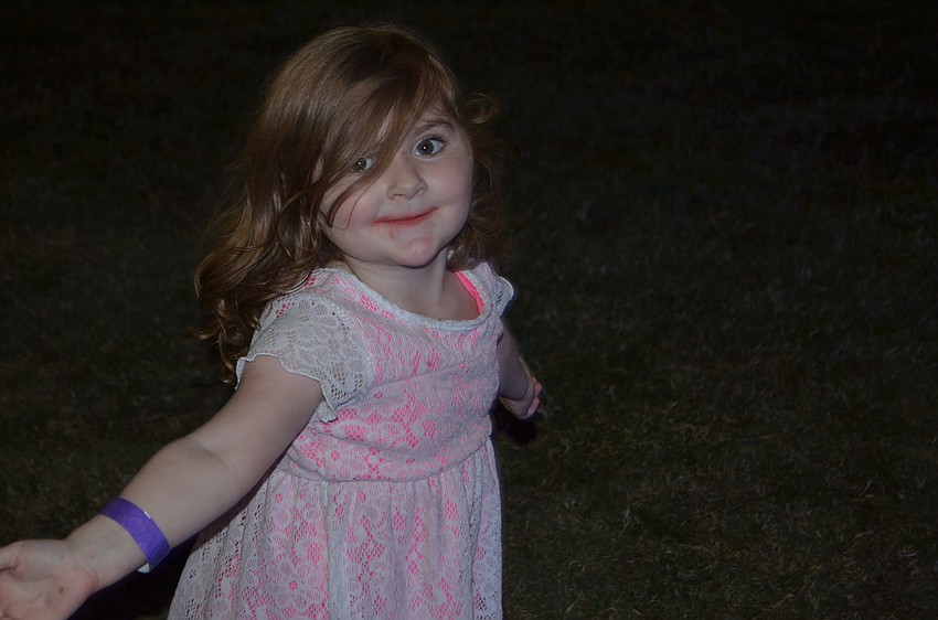 Bradenton's Charlotte Runck, 2, dances with her  Kona Ice lips.
